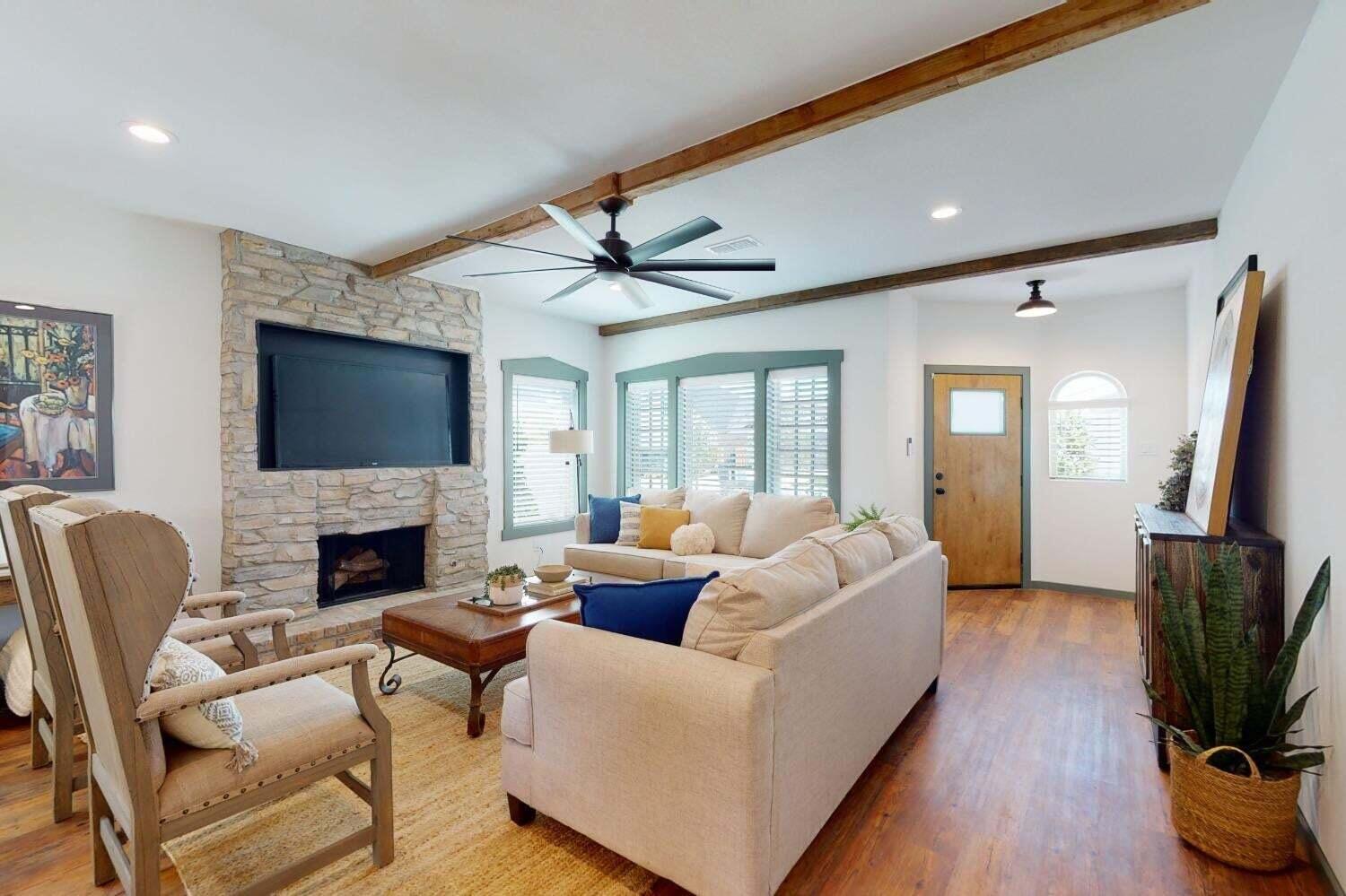 3617 128th Street Lubbock, TX 79423 - Photo 2 of 30 a living room with fireplace furniture and a flat screen tv