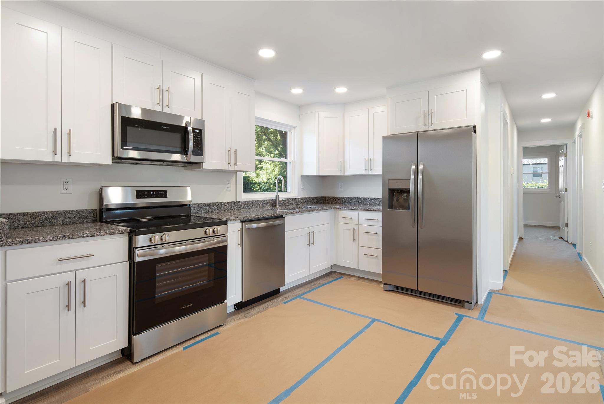 287 Duncan Road Flat Rock, NC 28731 - Photo 5 of 13 a kitchen with stainless steel appliances granite countertop a stove a refrigerator and a microwave
