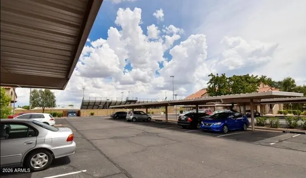 a view of a cars park in front of a building
