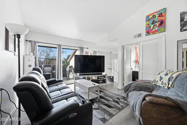 a living room with furniture and a flat screen tv