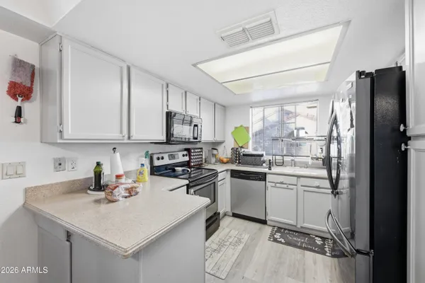 a kitchen with a sink appliances and cabinets