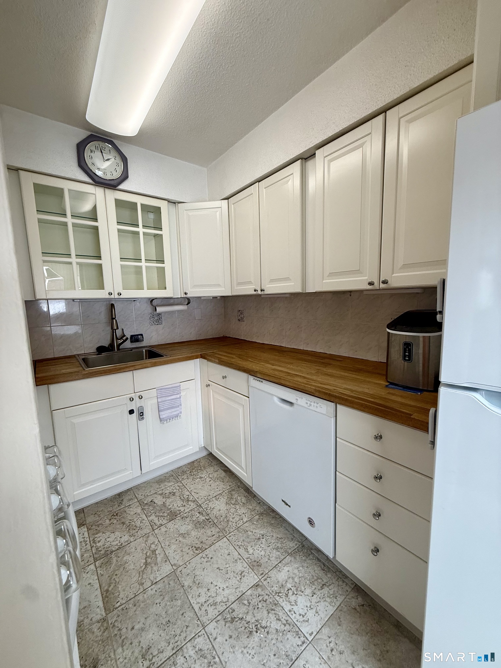 6 Stonegate Circle, Unit A Branford, CT 06405 - Photo 11 of 19 a kitchen with granite countertop a stove a sink and white cabinets