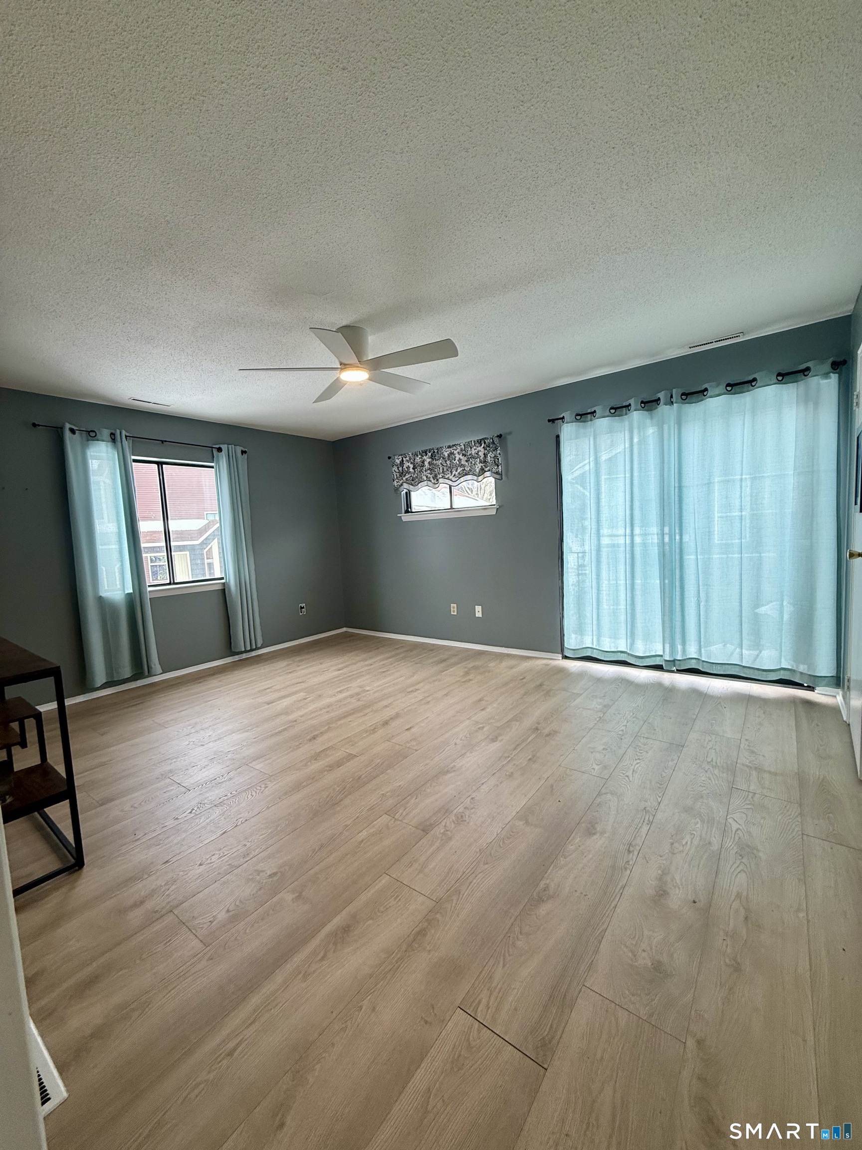 6 Stonegate Circle, Unit A Branford, CT 06405 - Photo 12 of 19 an empty room with wooden floor and windows
