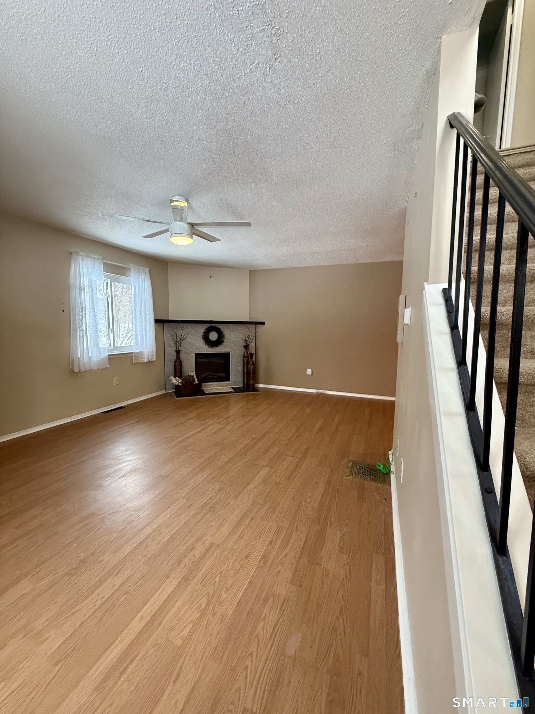 6 Stonegate Circle, Unit A Branford, CT 06405 - Photo 5 of 19 wooden floor in an empty room with a window