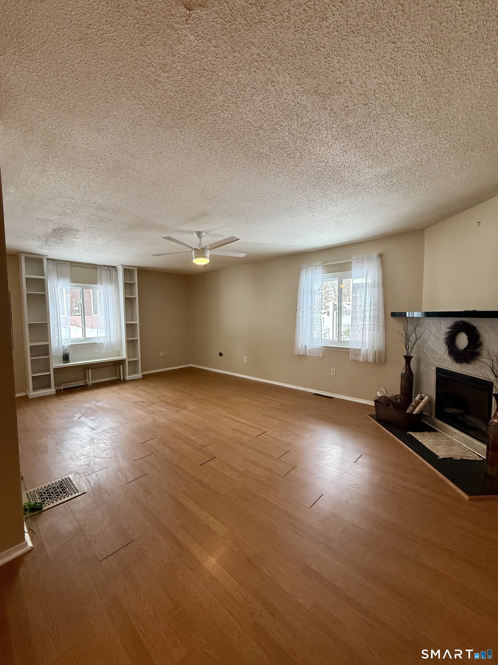 6 Stonegate Circle, Unit A Branford, CT 06405 - Photo 7 of 19 a view of empty room with wooden floor and fan