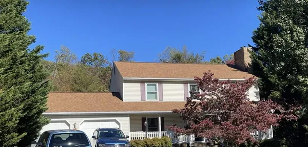a aerial view of a house with a yard and balcony