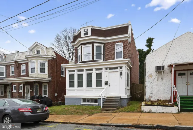 a front view of a residential apartment building with a yard
