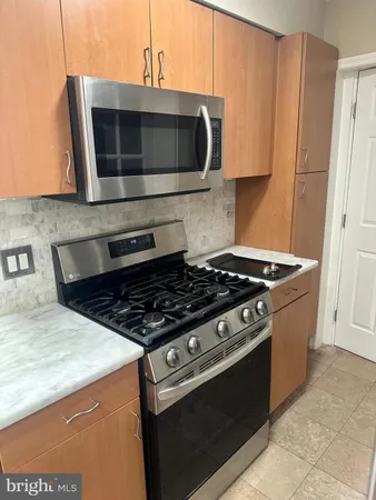 a kitchen with granite countertop a sink and a stove