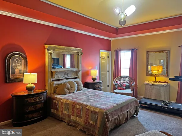 a bedroom with a bed and dresser