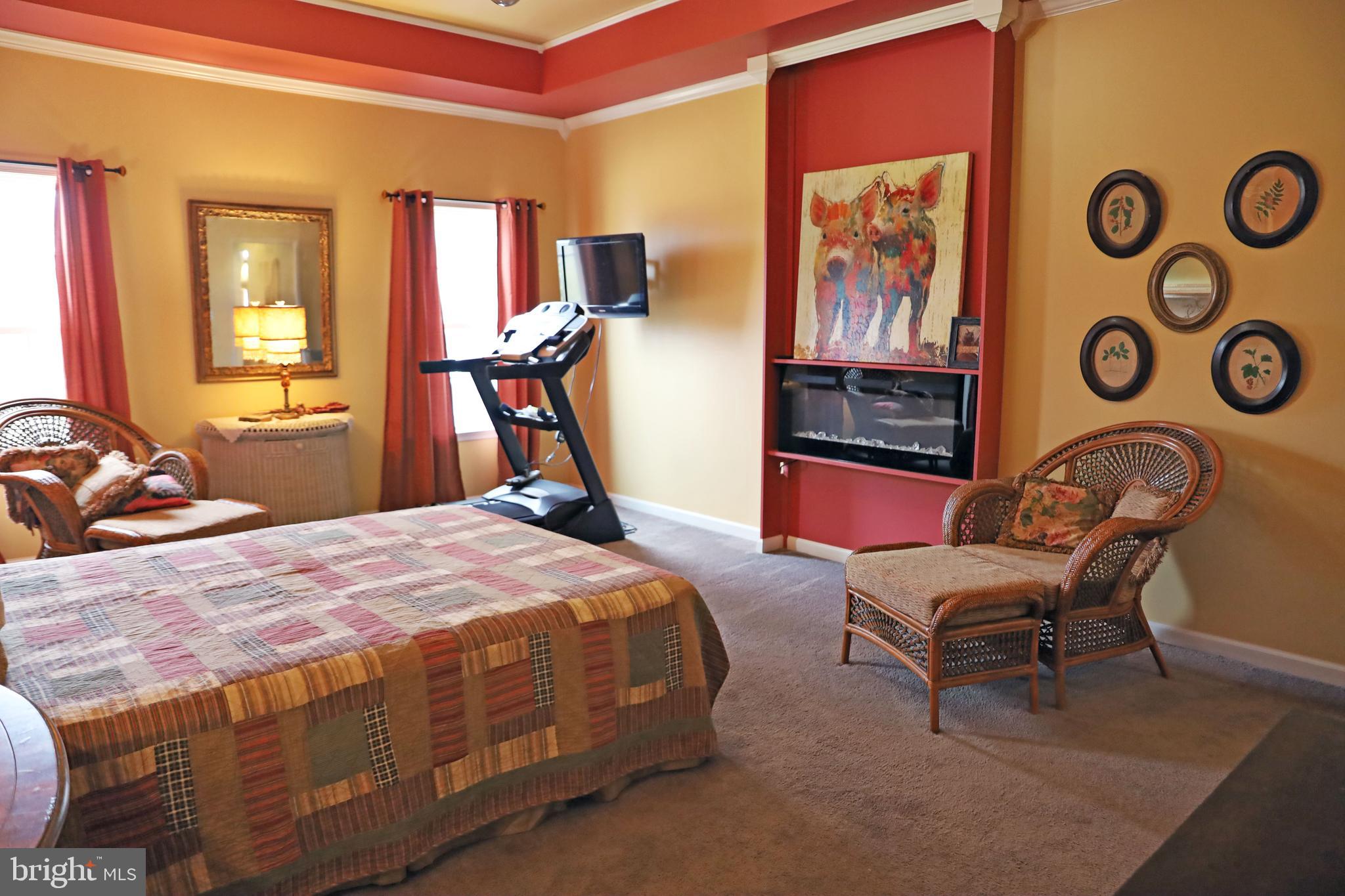 101 Trout River Terrace Falling Waters, WV 25419 - Photo 18 of 57 a bedroom with a bed and wooden floor