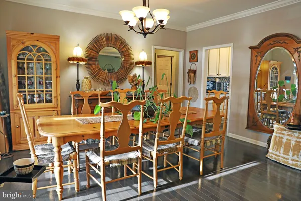 a view of a dining room with furniture wooden floor and chandelier
