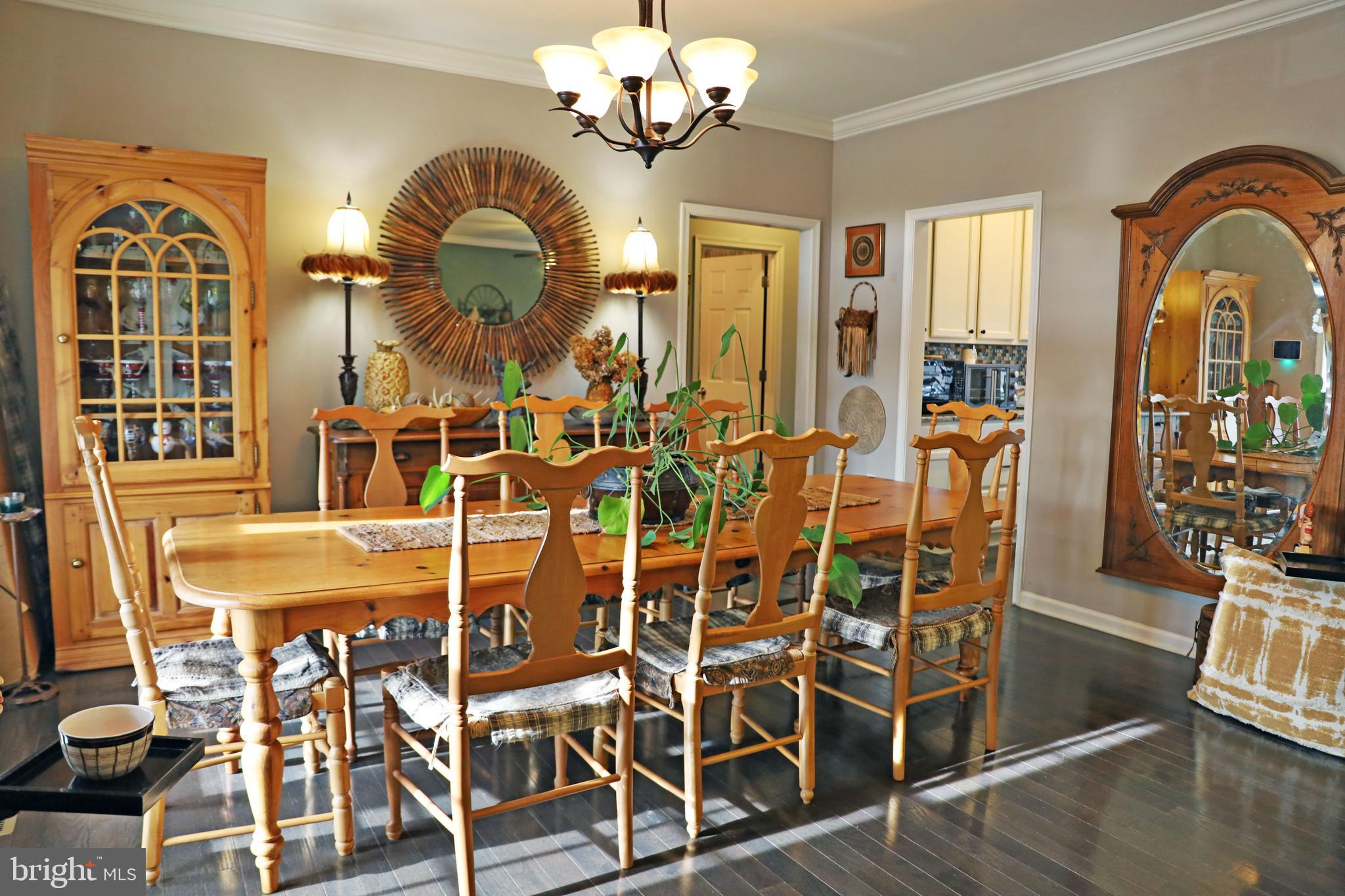 101 Trout River Terrace Falling Waters, WV 25419 - Photo 2 of 57 a view of a dining room with furniture wooden floor and chandelier