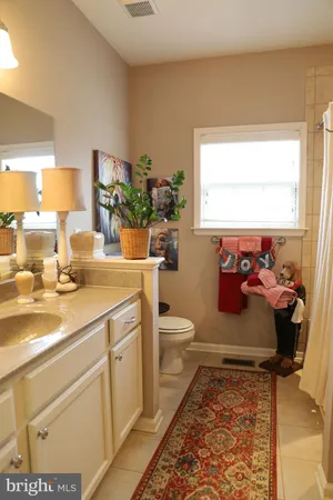 a bathroom with a toilet sink and window