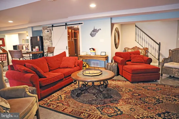 a living room with furniture a flat screen tv and a table
