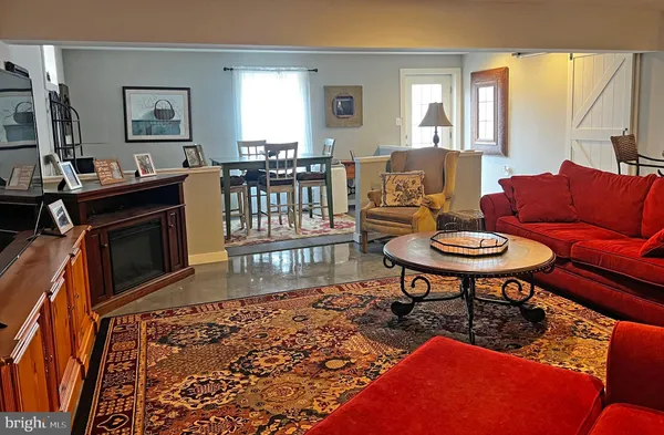 a room with lots of furniture and a chandelier