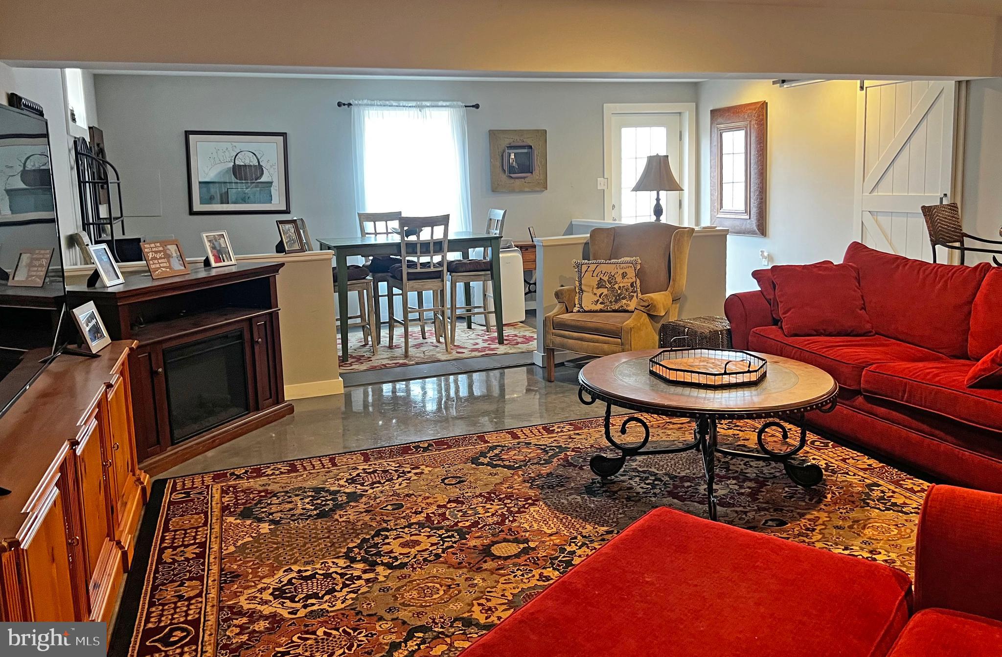 101 Trout River Terrace Falling Waters, WV 25419 - Photo 31 of 57 a living room with furniture a rug a window and a flat screen tv
