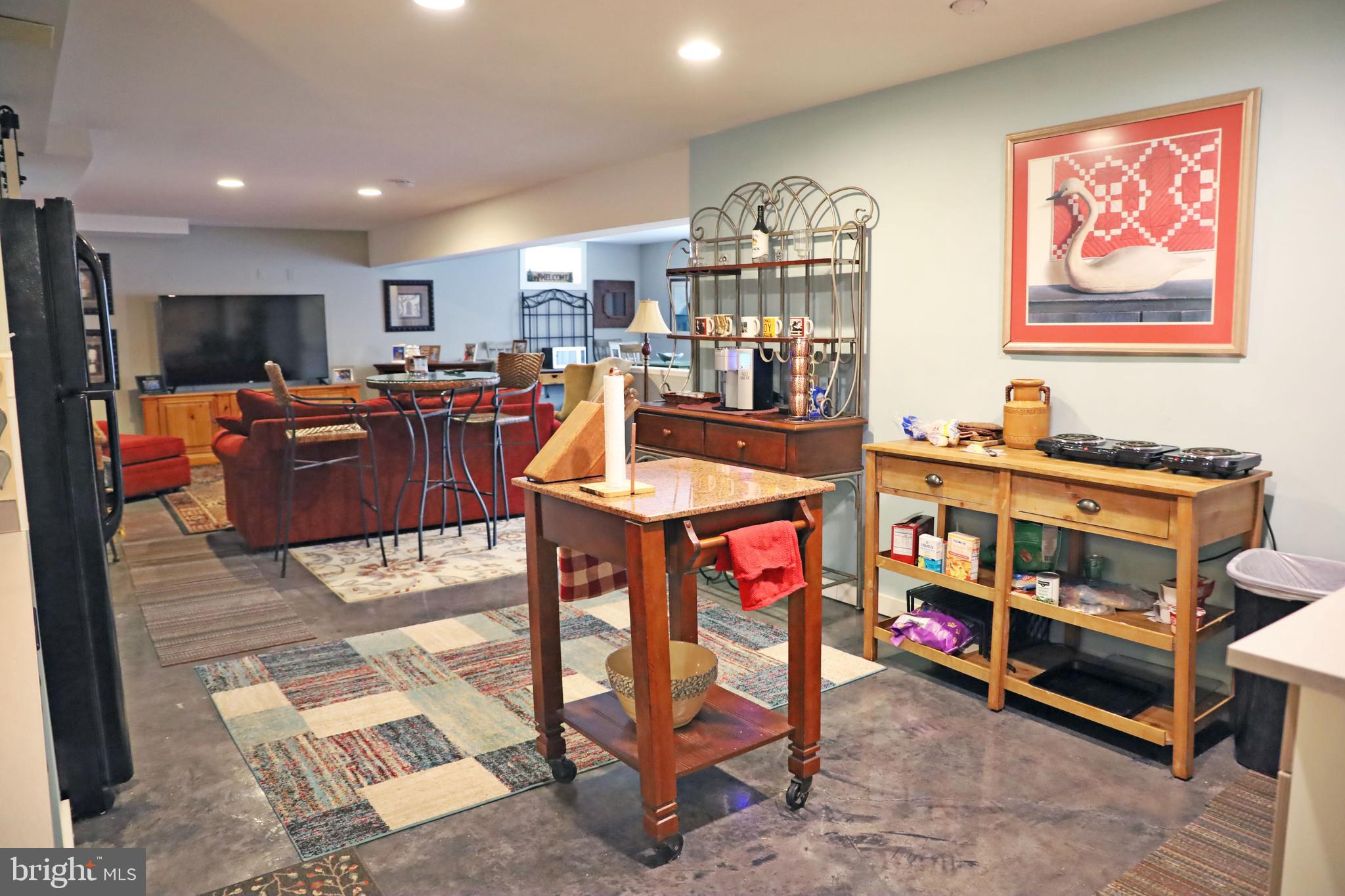 101 Trout River Terrace Falling Waters, WV 25419 - Photo 32 of 57 a living room with furniture a flat screen tv and a table