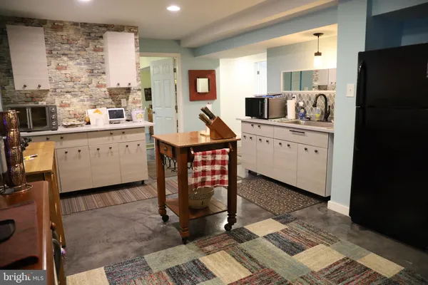 a view of a kitchen with furniture and a window