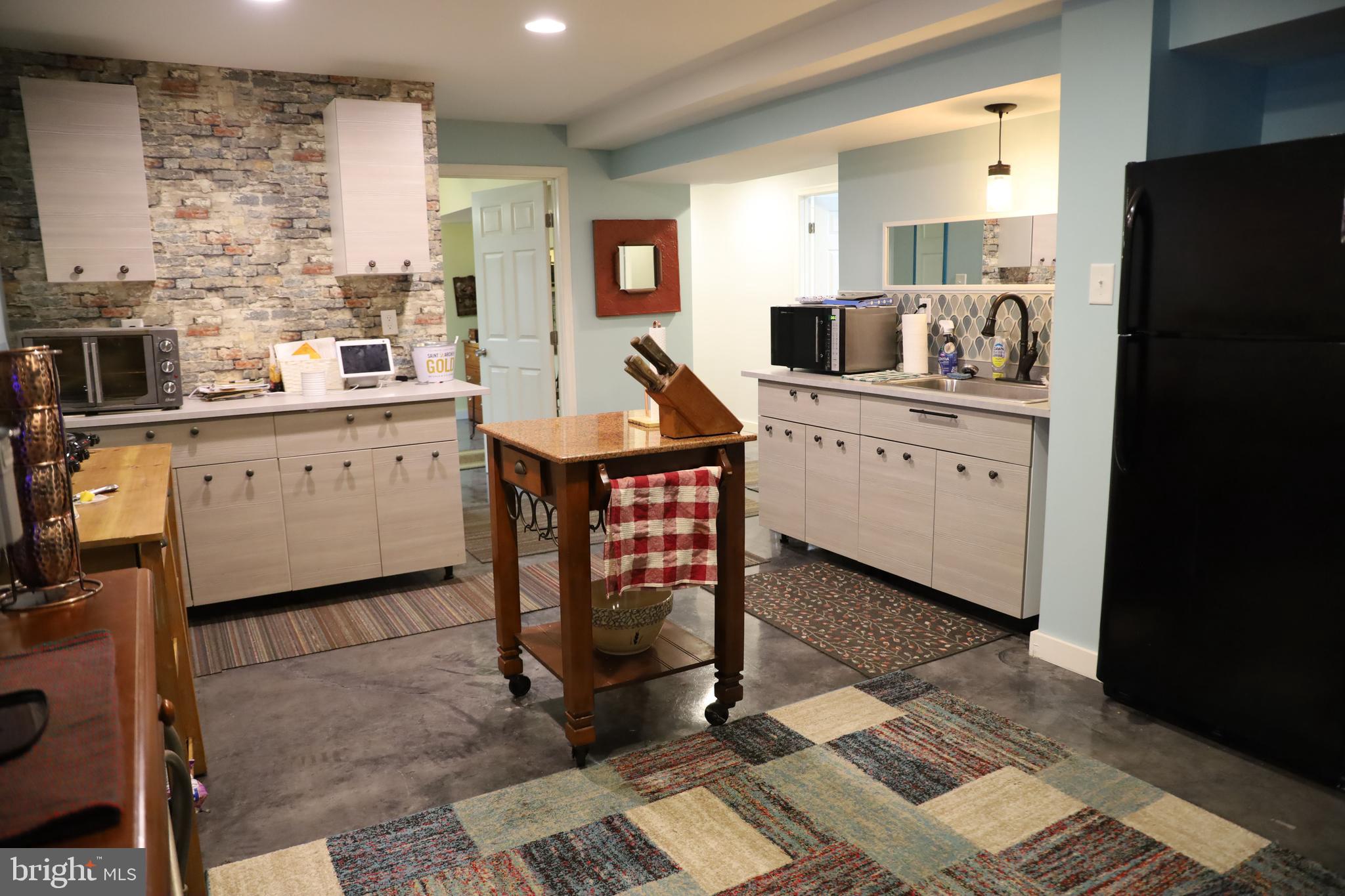 101 Trout River Terrace Falling Waters, WV 25419 - Photo 34 of 57 a kitchen with stainless steel appliances a stove refrigerator sink and cabinets