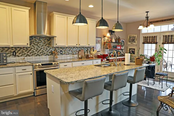 a kitchen with stainless steel appliances granite countertop a stove and a sink