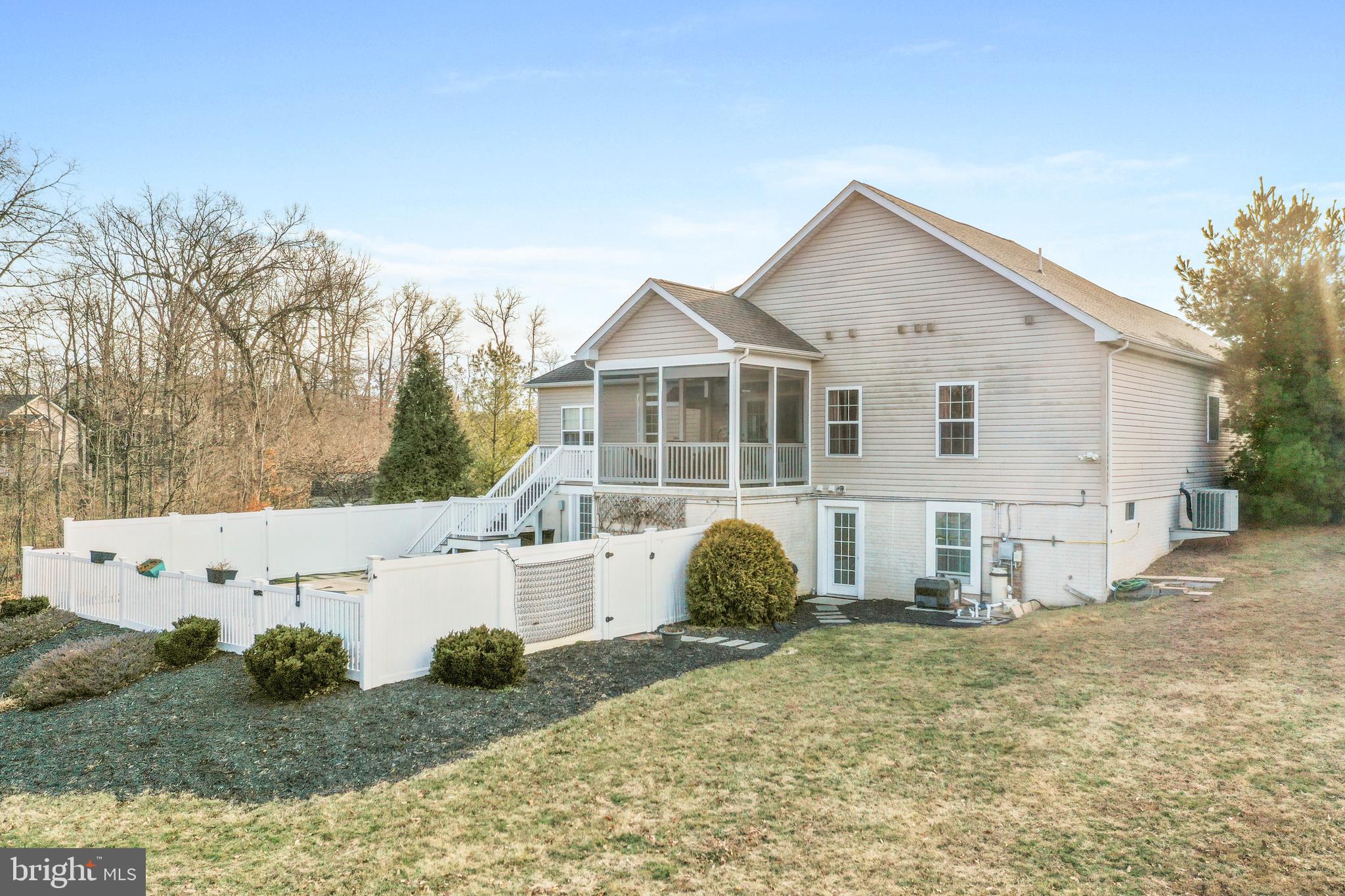 101 Trout River Terrace Falling Waters, WV 25419 - Photo 53 of 57 a view of a white house with a yard and potted plants