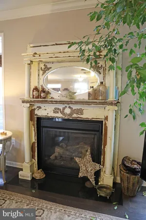 a room with furniture a chandelier and wooden floor
