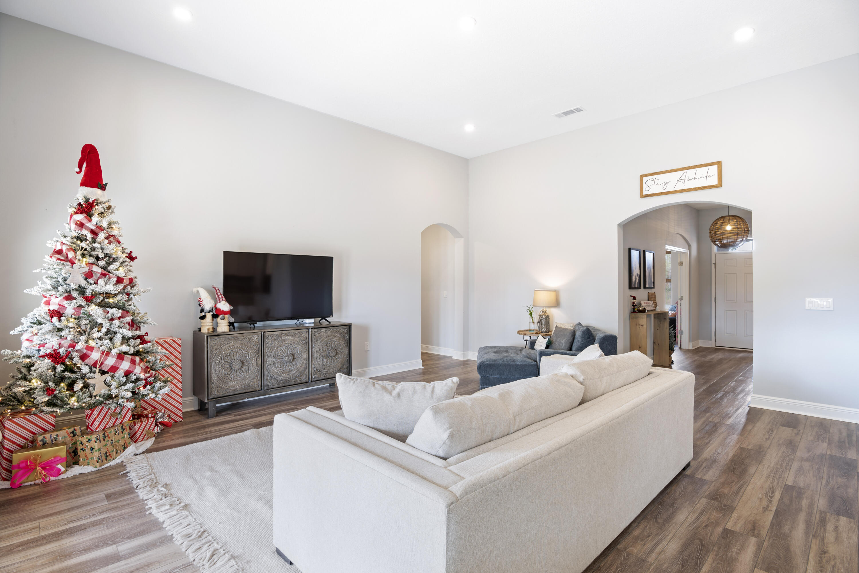 32 Brushed Dune Circle Freeport, FL 32439 - Photo 11 of 34 a living room with furniture a flat screen tv and a christmas tree