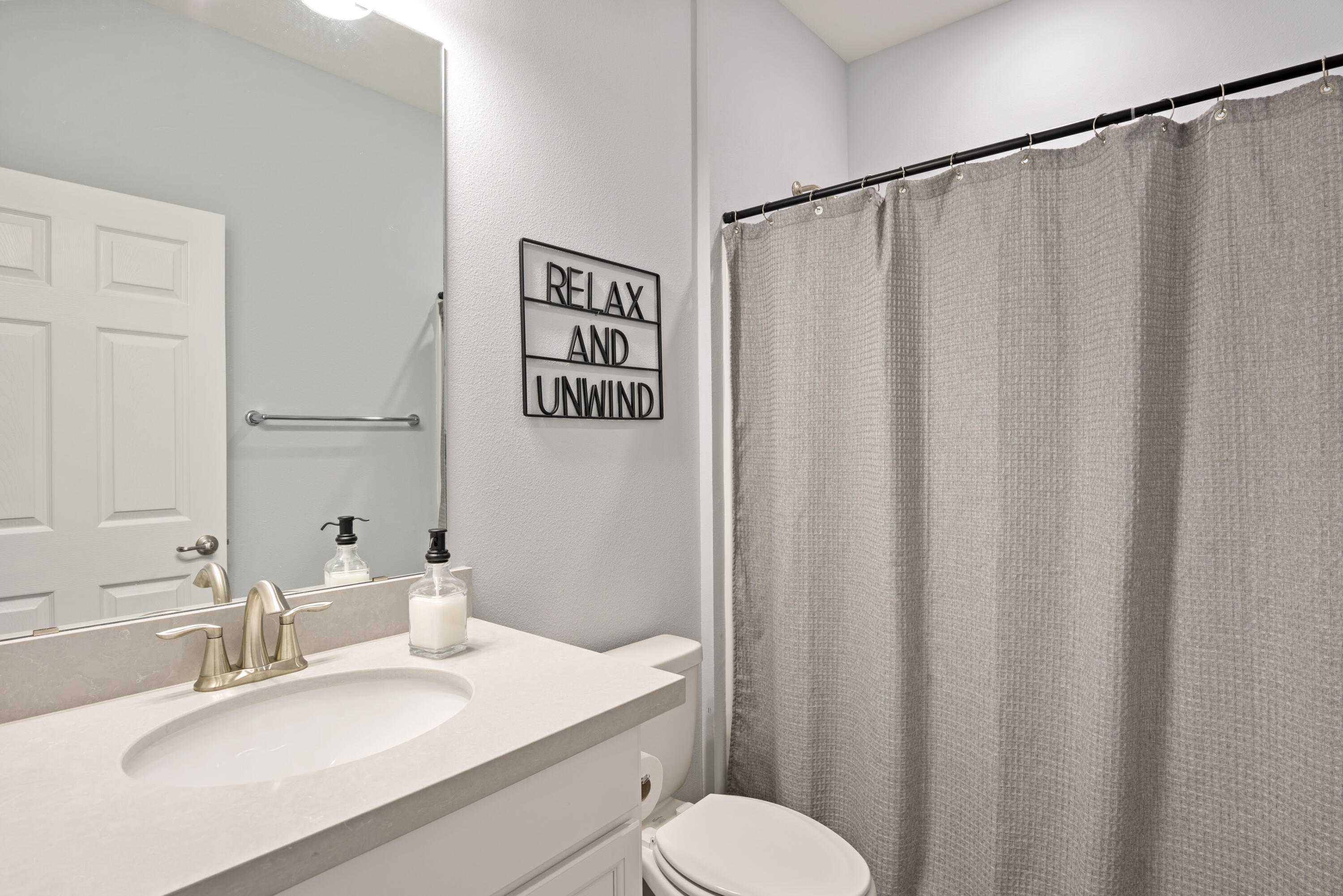 32 Brushed Dune Circle Freeport, FL 32439 - Photo 19 of 34 a bathroom with a sink and a mirror