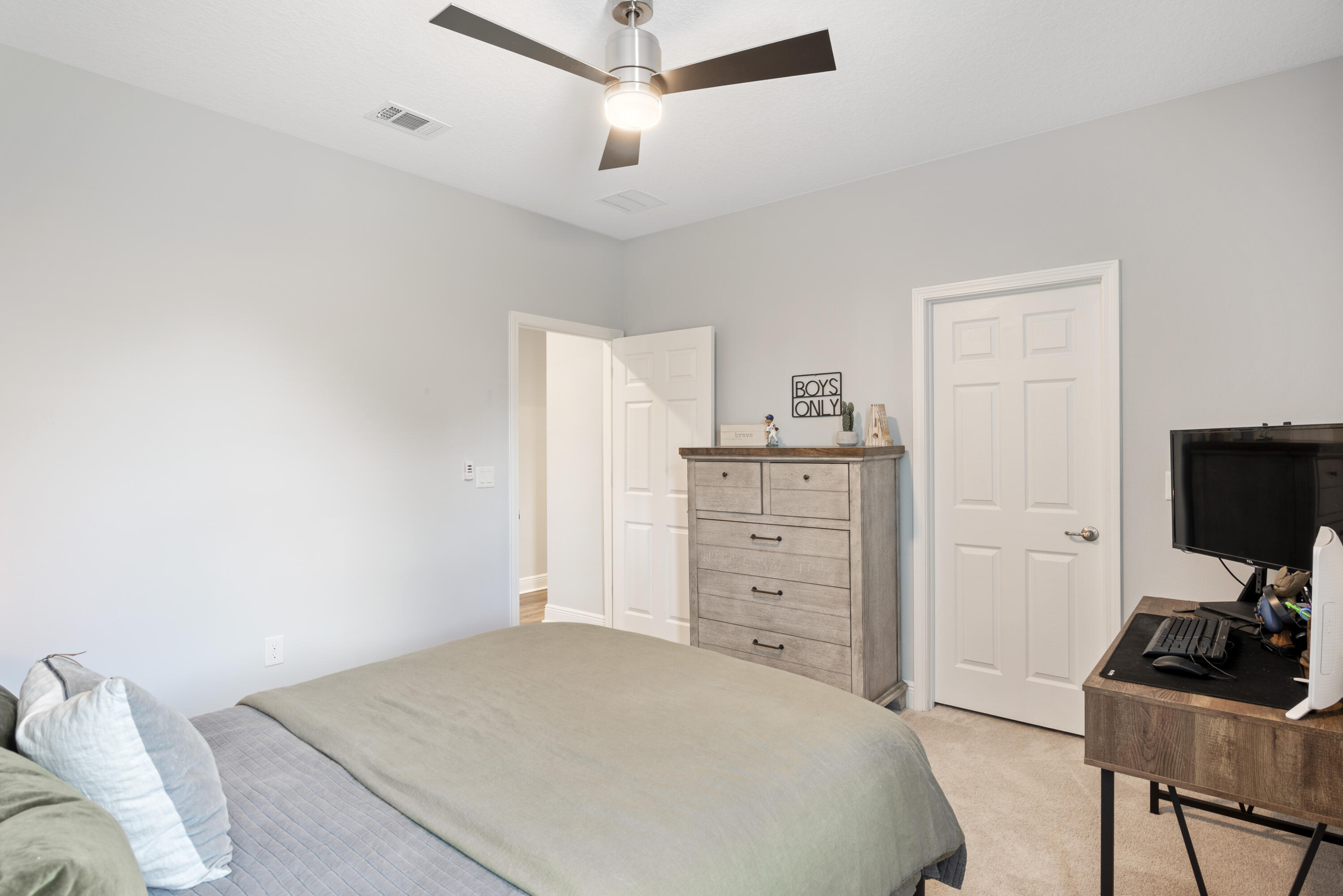 32 Brushed Dune Circle Freeport, FL 32439 - Photo 20 of 34 a bedroom with a bed and a flat screen tv