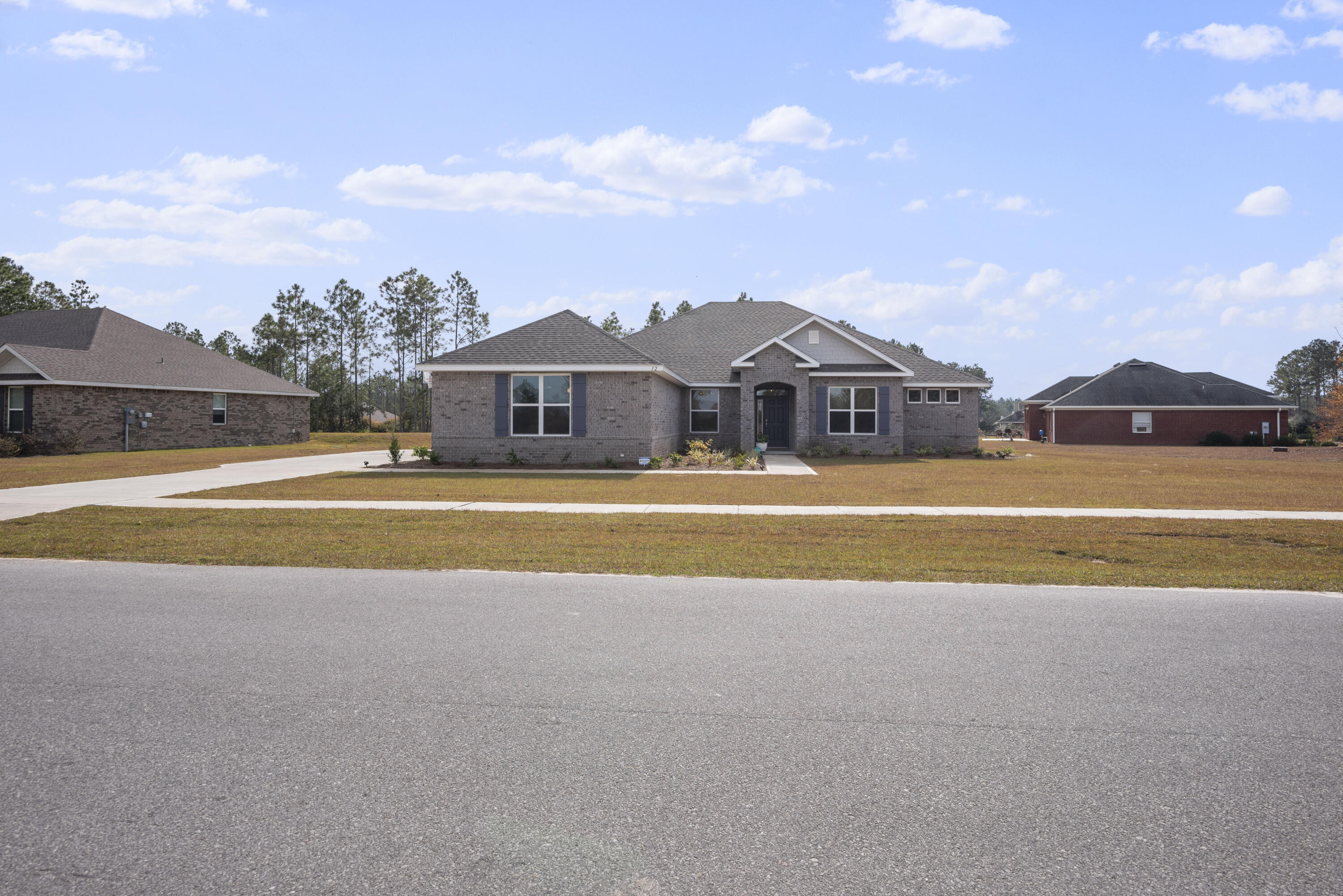 32 Brushed Dune Circle Freeport, FL 32439 - Photo 2 of 34 a view of large house with a big yard and large trees