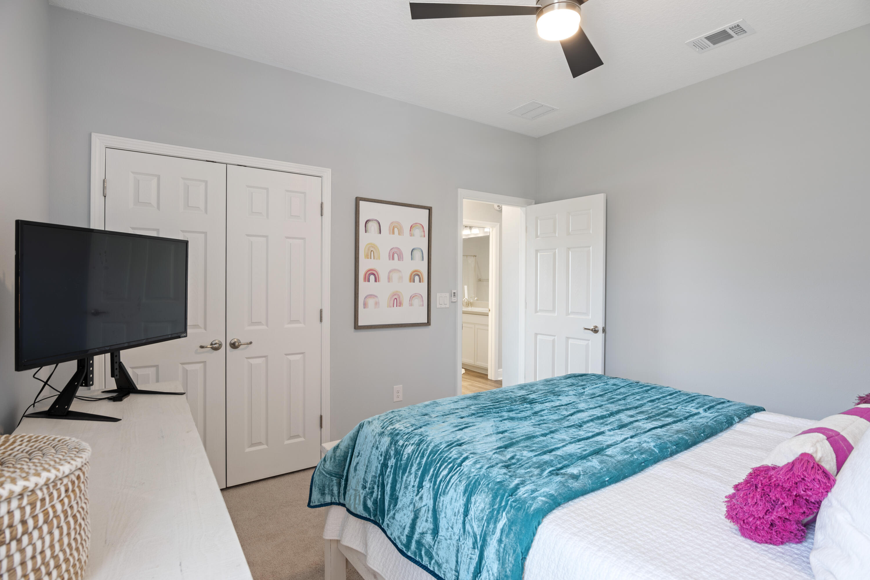 32 Brushed Dune Circle Freeport, FL 32439 - Photo 25 of 34 a bedroom with a bed and a flat screen tv