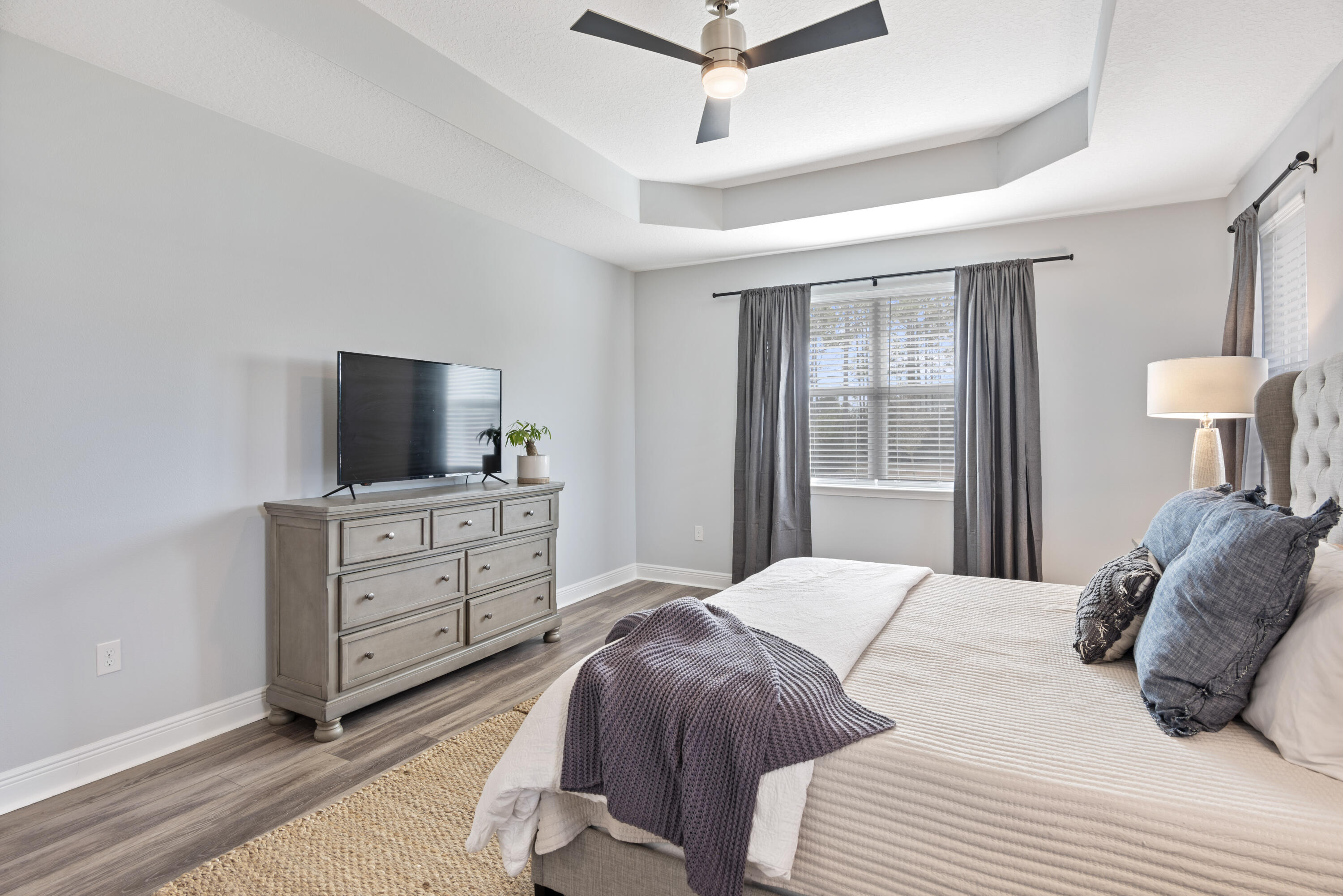 32 Brushed Dune Circle Freeport, FL 32439 - Photo 28 of 34 a bedroom with a bed and a flat screen tv