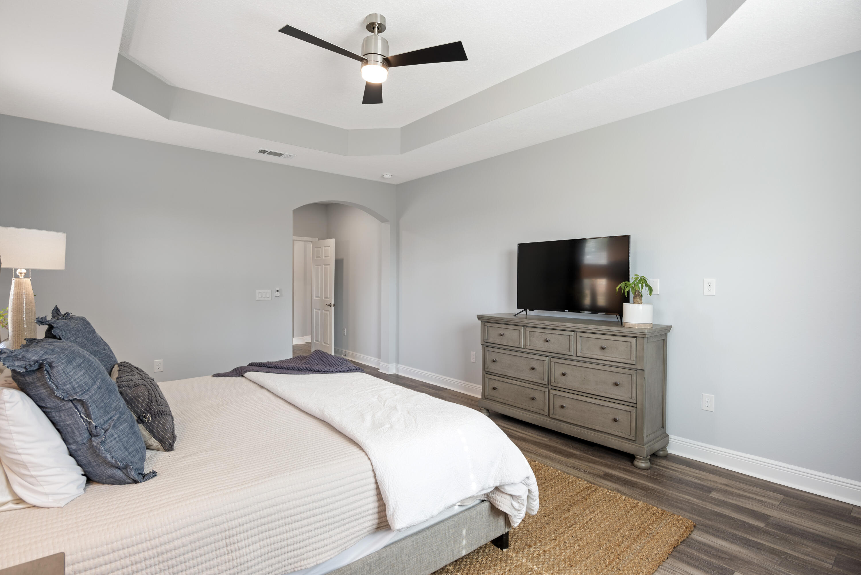 32 Brushed Dune Circle Freeport, FL 32439 - Photo 29 of 34 a bedroom with a bed and a flat screen tv