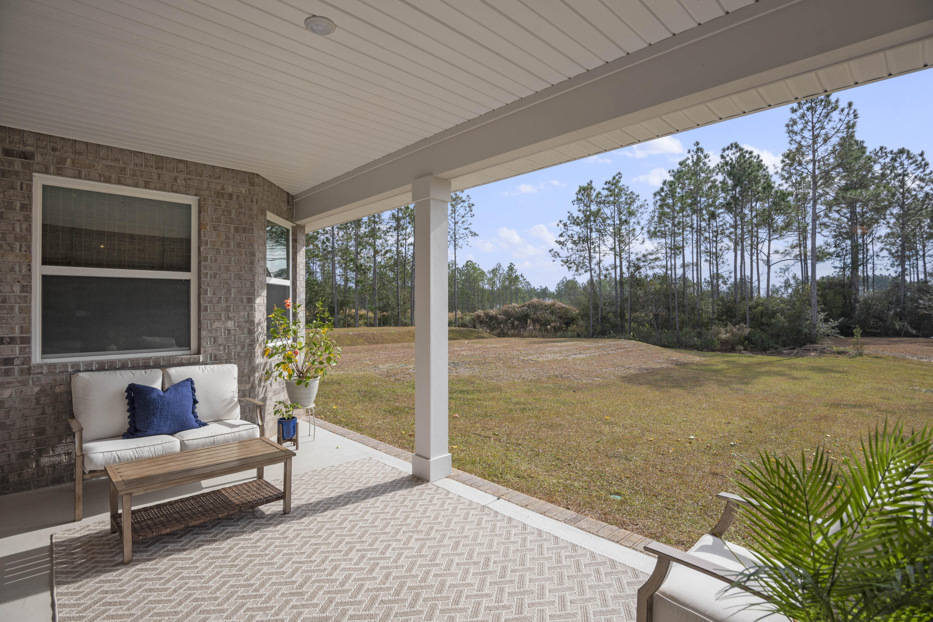 32 Brushed Dune Circle Freeport, FL 32439 - Photo 33 of 34 a balcony with furniture and a garden
