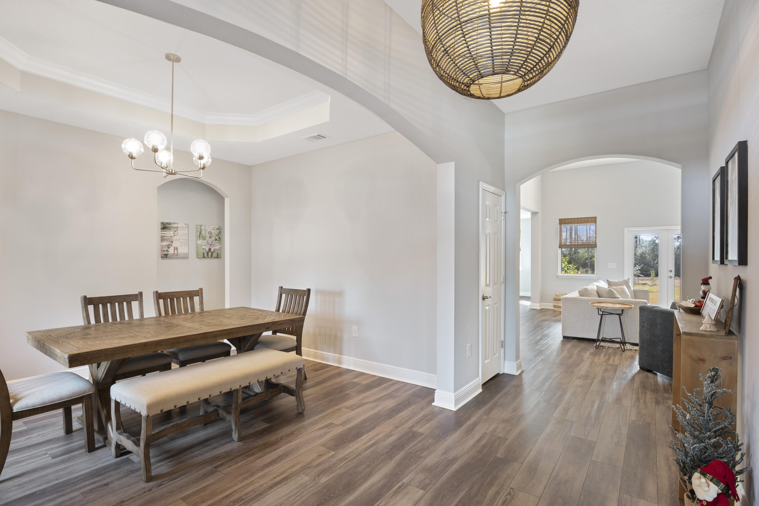 32 Brushed Dune Circle Freeport, FL 32439 - Photo 7 of 34 a dining room with wooden floor a chandelier a wooden table and chairs