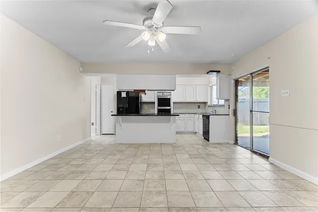 a view of kitchen with stainless steel appliances a refrigerator and a stove top oven