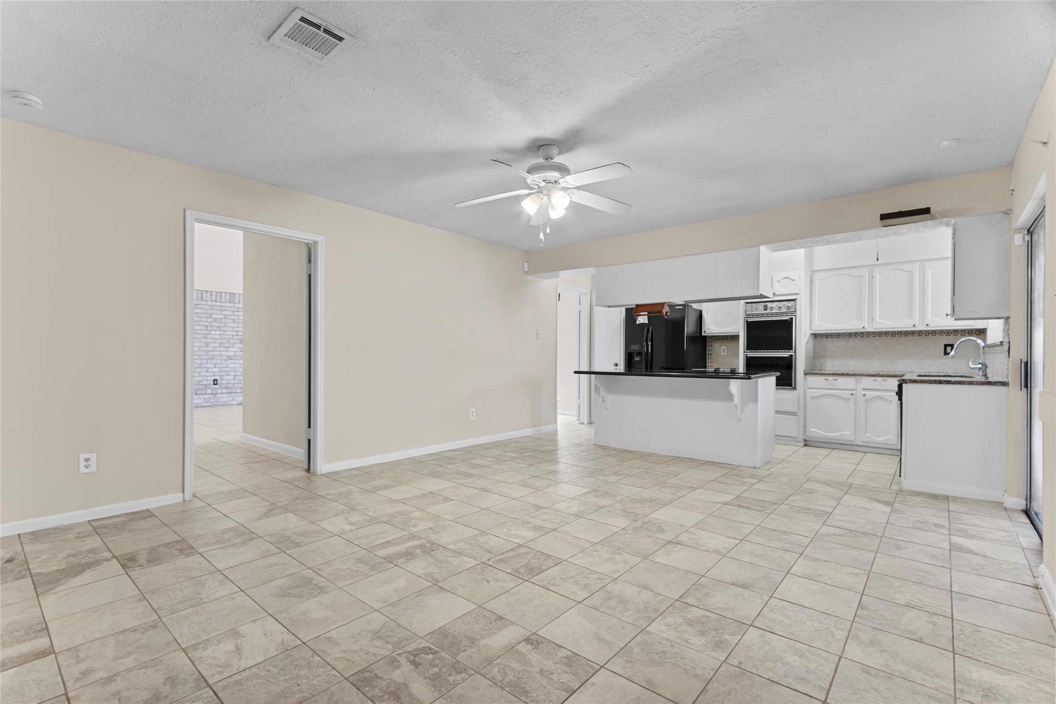 6630 Brownie Campbell Road Houston, TX 77086 - Photo 12 of 28 a view of kitchen with stainless steel appliances a refrigerator and a stove top oven