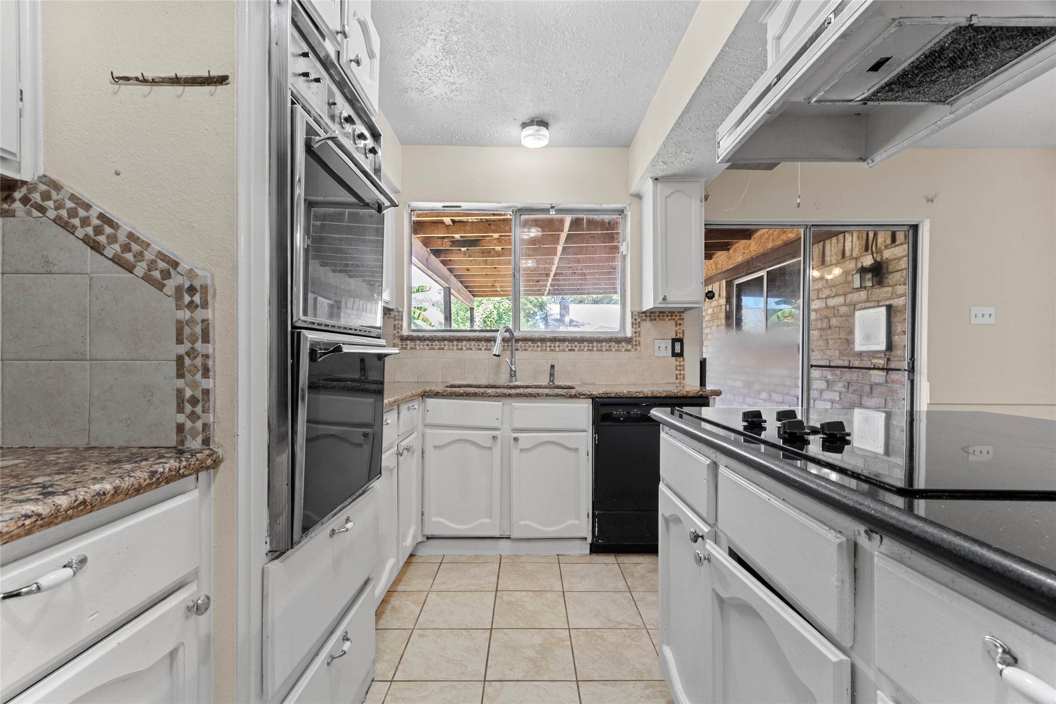 6630 Brownie Campbell Road Houston, TX 77086 - Photo 13 of 28 a kitchen with a sink stove and cabinets