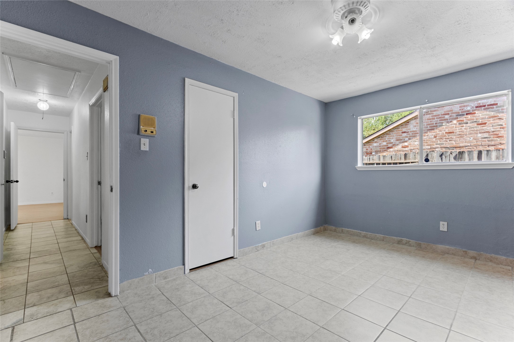 6630 Brownie Campbell Road Houston, TX 77086 - Photo 16 of 28 a view of an empty room with window and chandelier fan