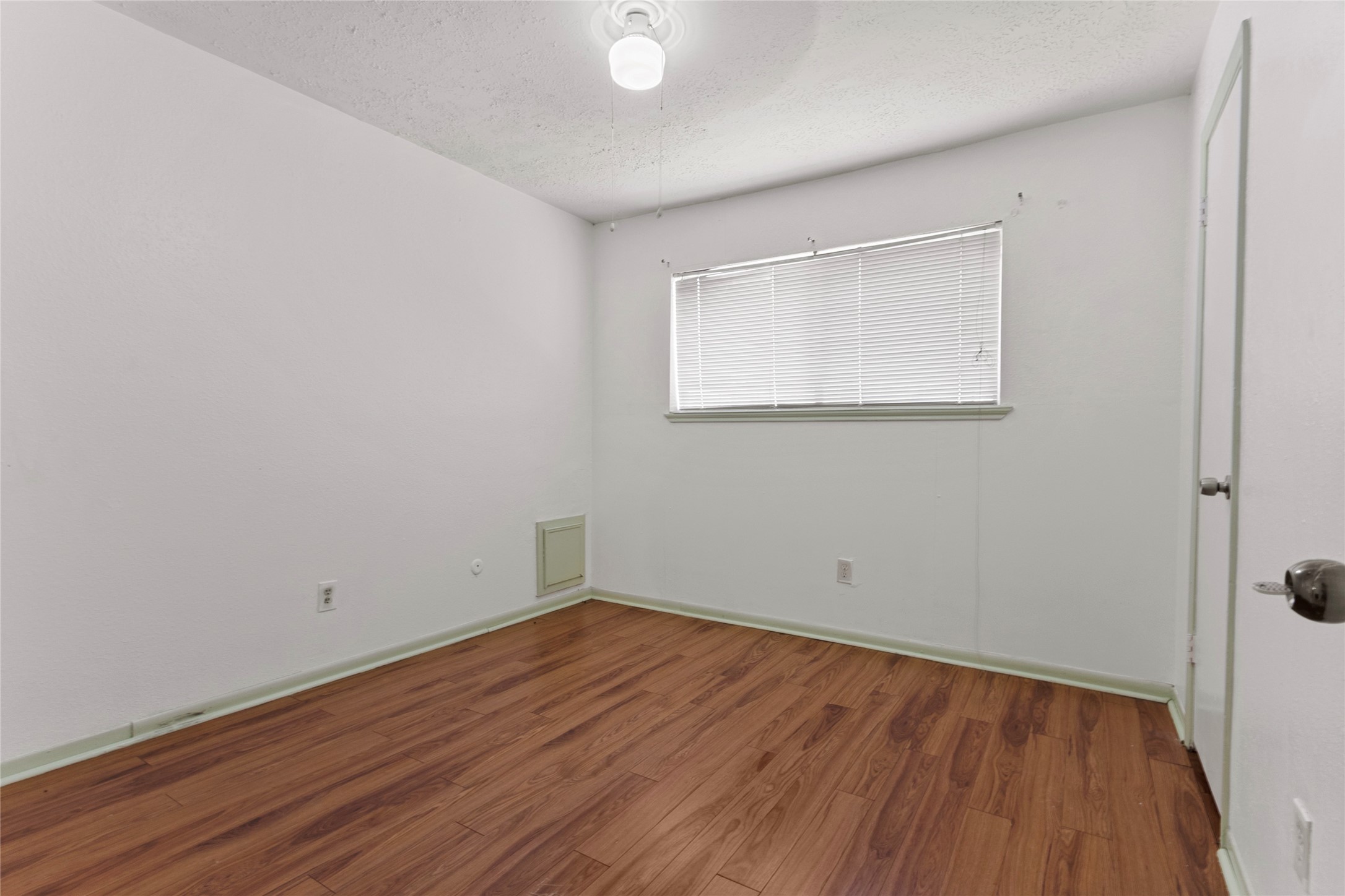 6630 Brownie Campbell Road Houston, TX 77086 - Photo 17 of 28 a view of a room with wooden floor and white walls