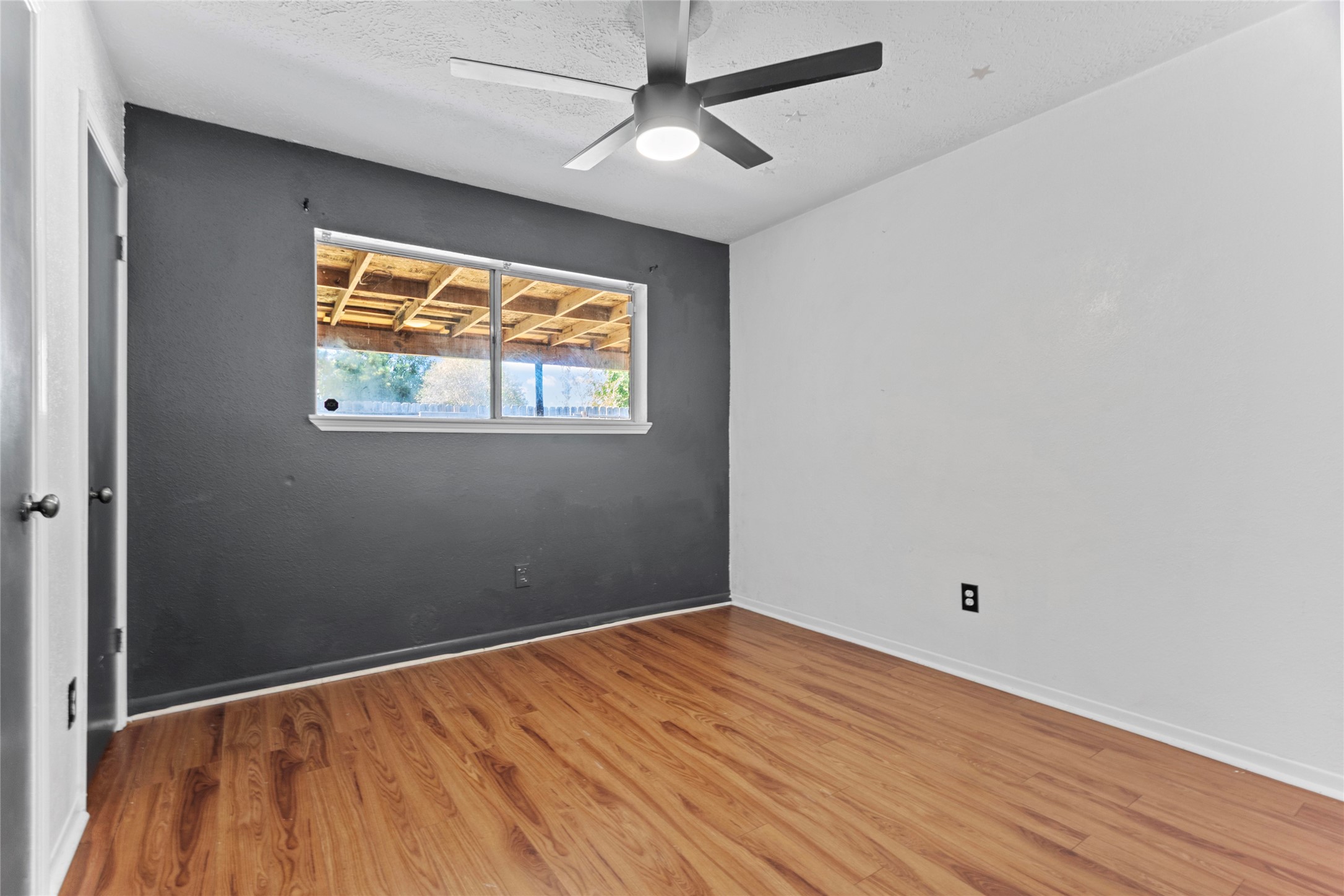 6630 Brownie Campbell Road Houston, TX 77086 - Photo 18 of 28 a view of empty room with wooden floor