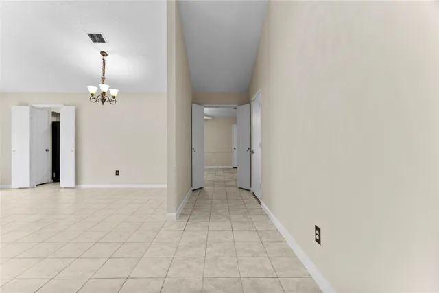 a view of a hallway with chandelier