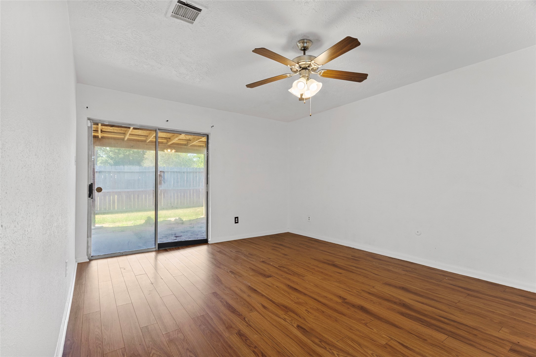 6630 Brownie Campbell Road Houston, TX 77086 - Photo 21 of 28 wooden floor in an empty room with a window
