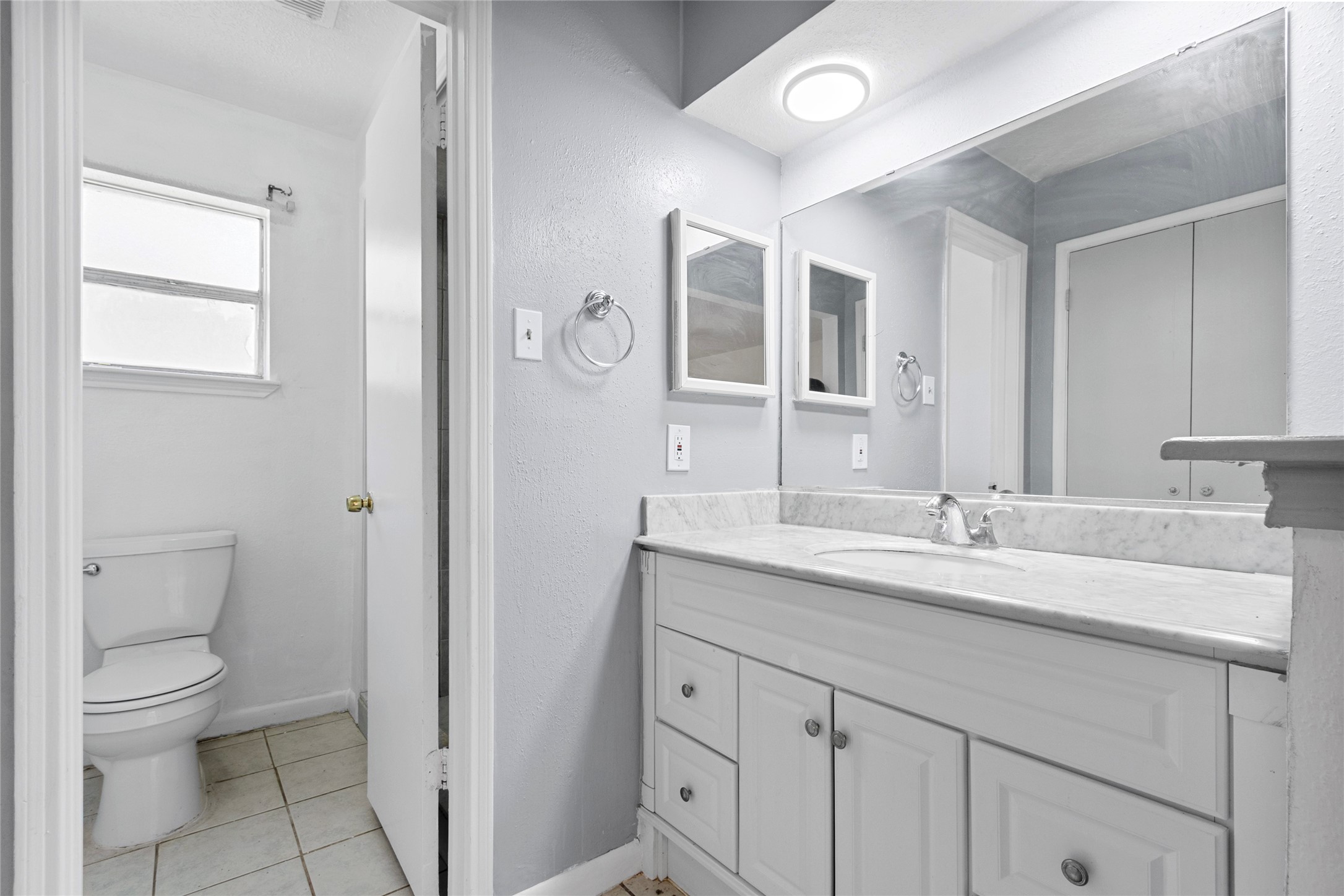 6630 Brownie Campbell Road Houston, TX 77086 - Photo 23 of 28 a bathroom with a granite countertop sink a toilet and a mirror