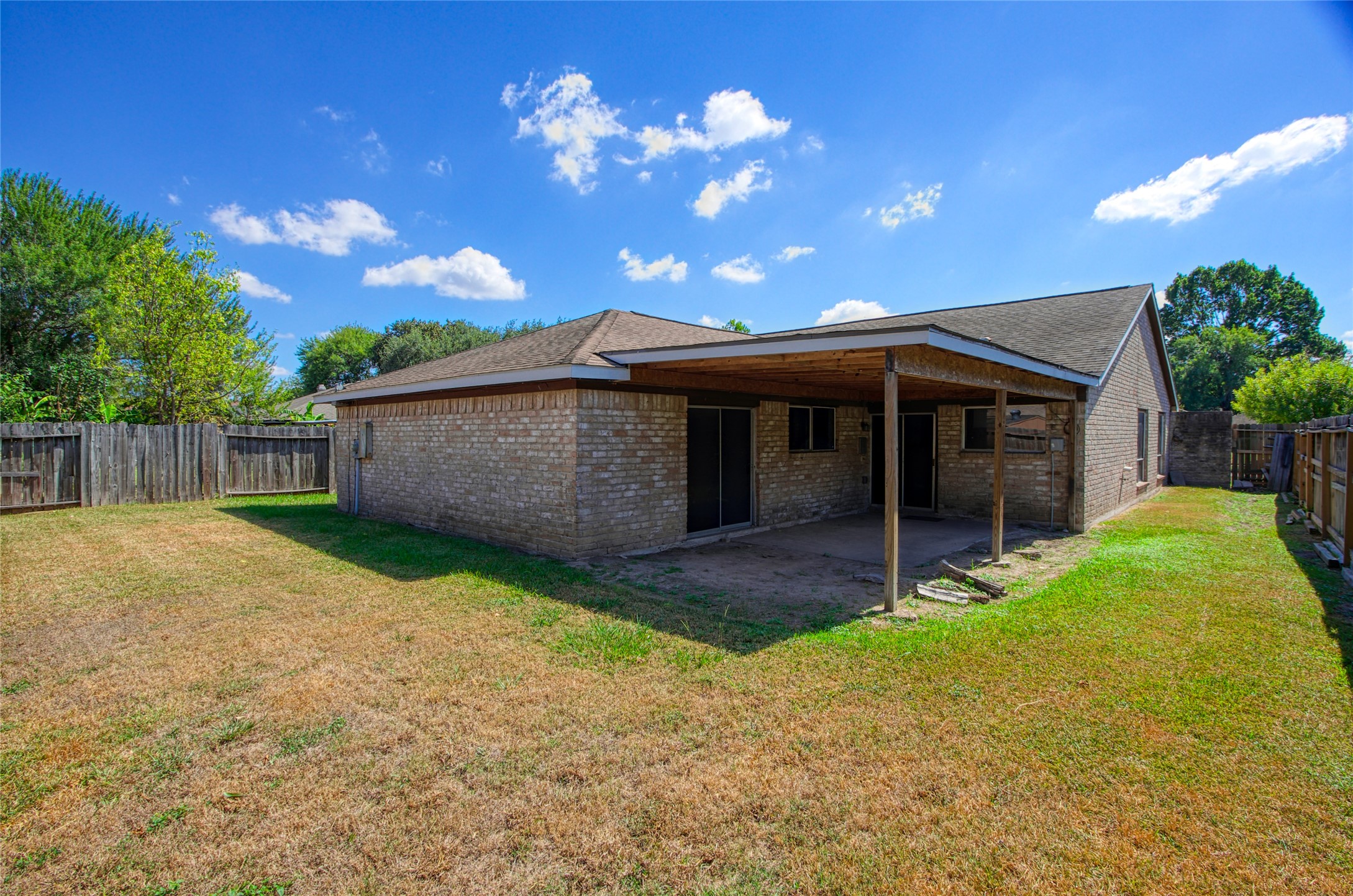 6630 Brownie Campbell Road Houston, TX 77086 - Photo 25 of 28 a backyard of a house with plants and wooden fence