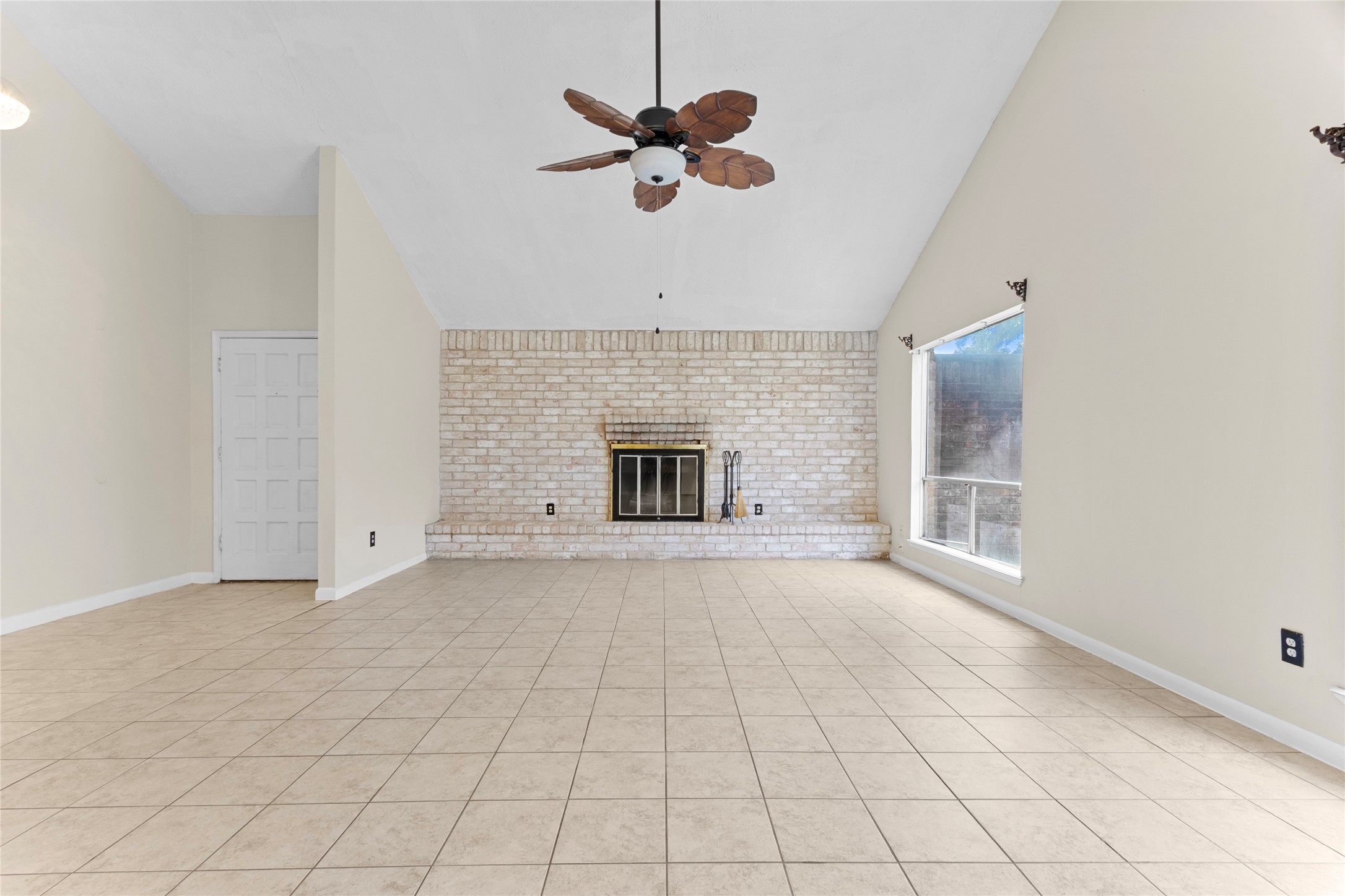 6630 Brownie Campbell Road Houston, TX 77086 - Photo 5 of 28 an empty room with fireplace and windows