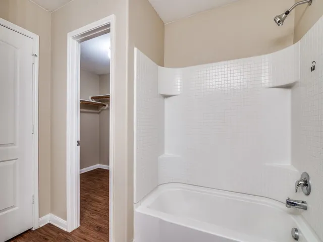 a bathroom with a bathtub and shower