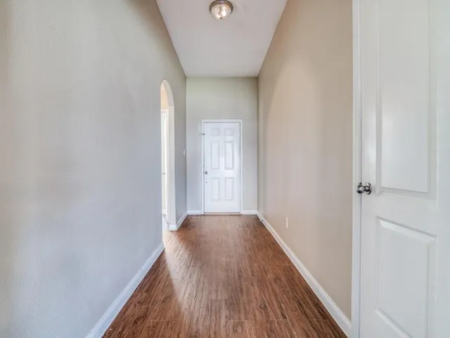 a view of a hallway with wooden floor