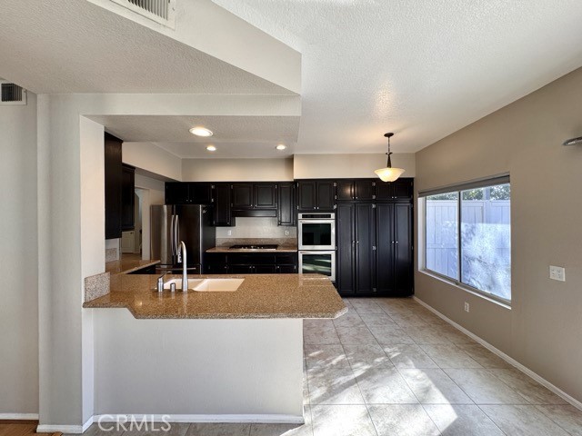 40085 Temecky Way Murrieta, CA 92562 - Photo 15 of 55 a view of kitchen with refrigerator and window
