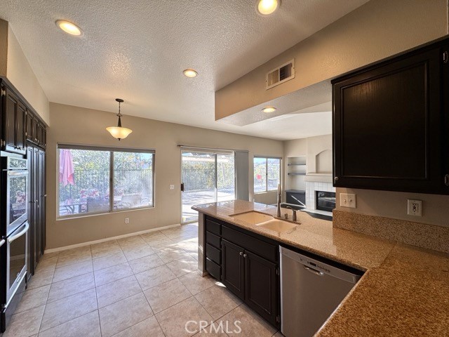 40085 Temecky Way Murrieta, CA 92562 - Photo 20 of 55 a large kitchen with kitchen island granite countertop a sink and a stove top oven a granite countertops with wooden floor